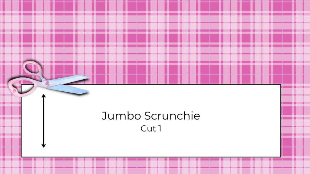 Pink plaid fabric with a jumbo scrunchie pattern layed out on top.  a pair of scissors cut it out.