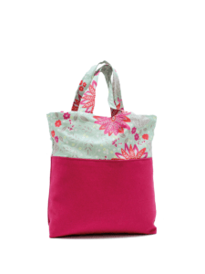 A pink tote bag with a floral design